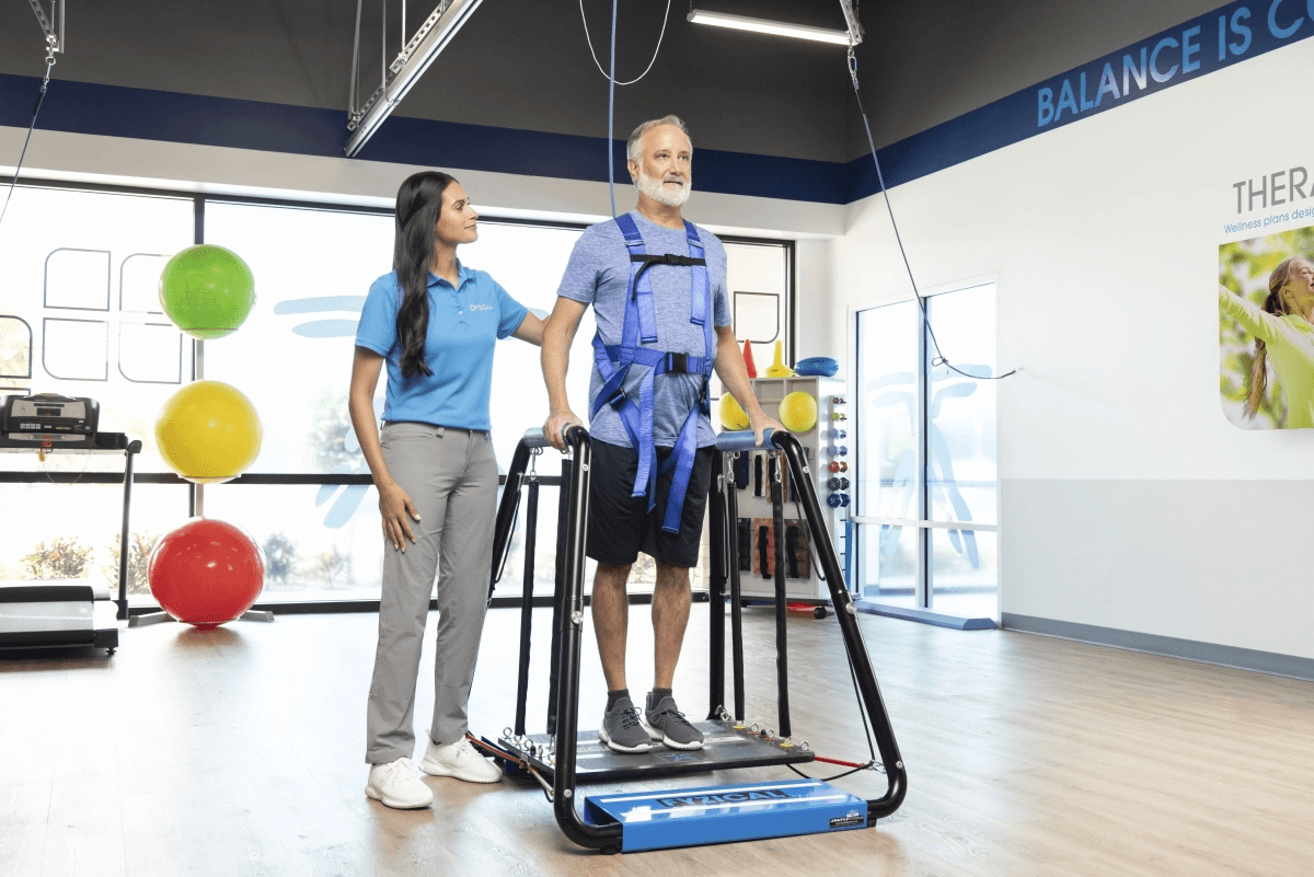 Physical therapist supporting a patient in balance equipment
