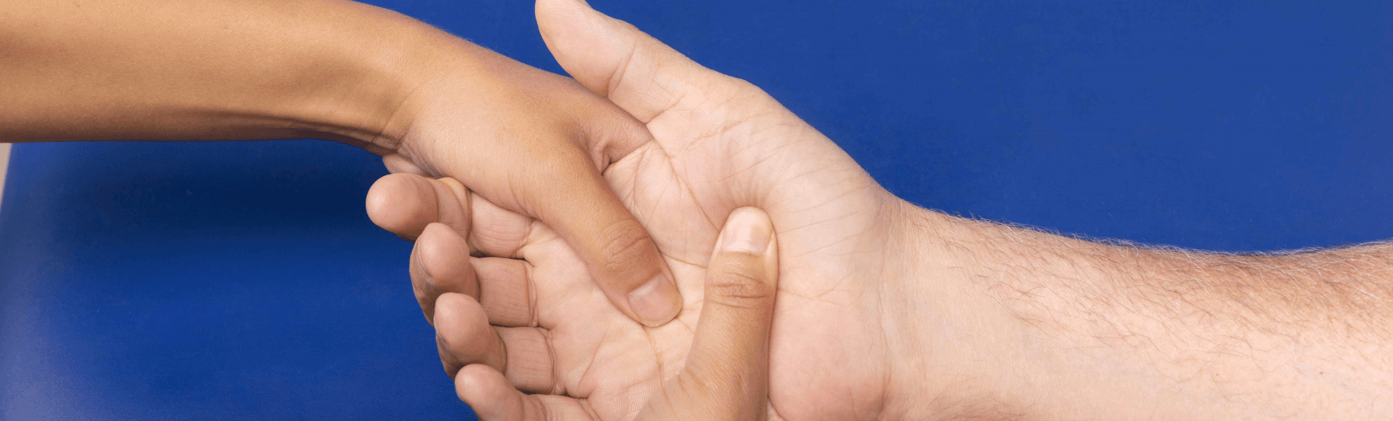 Hands receiving gentle support during a therapy session